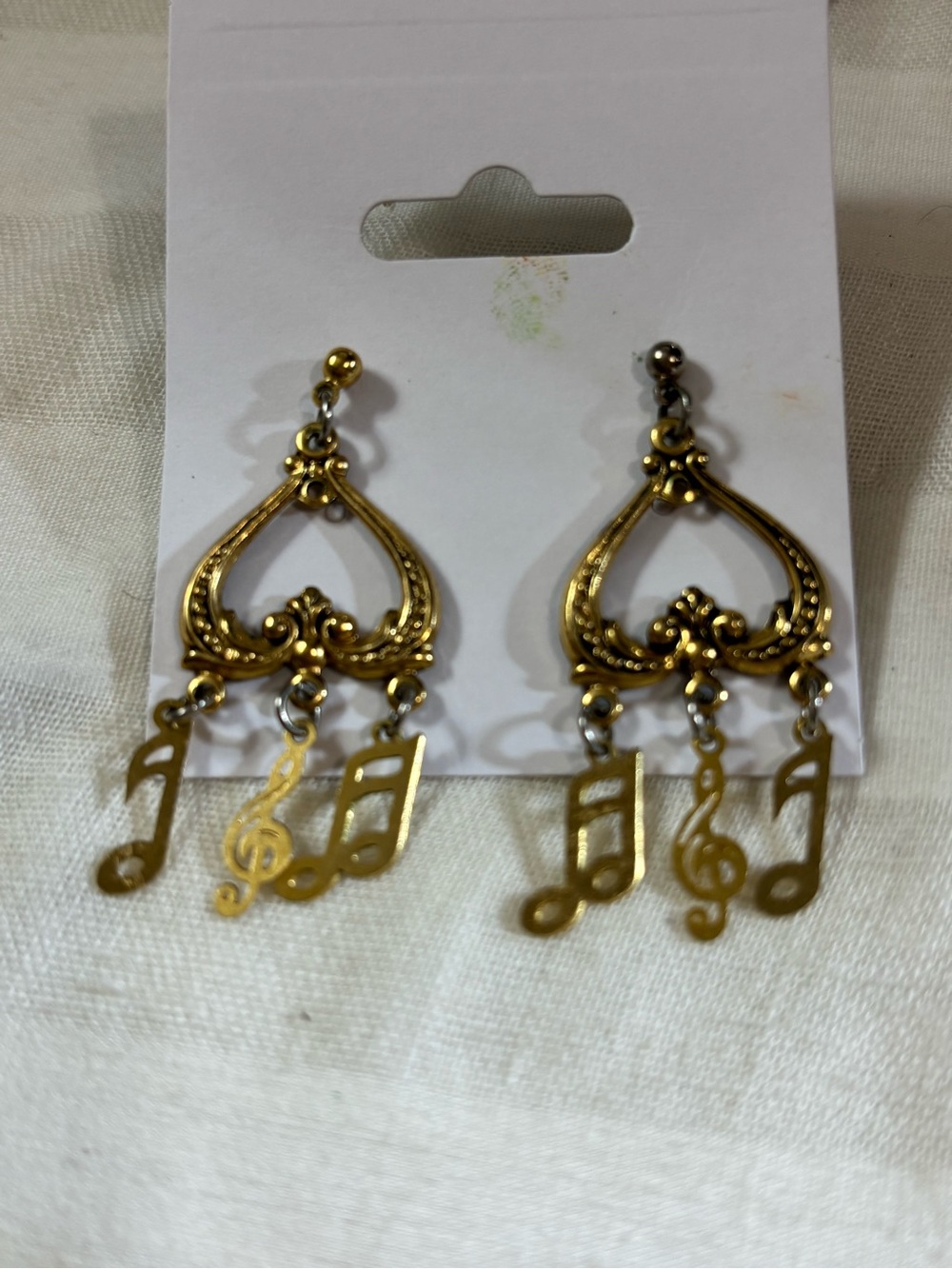 Brass tone musical earrings
